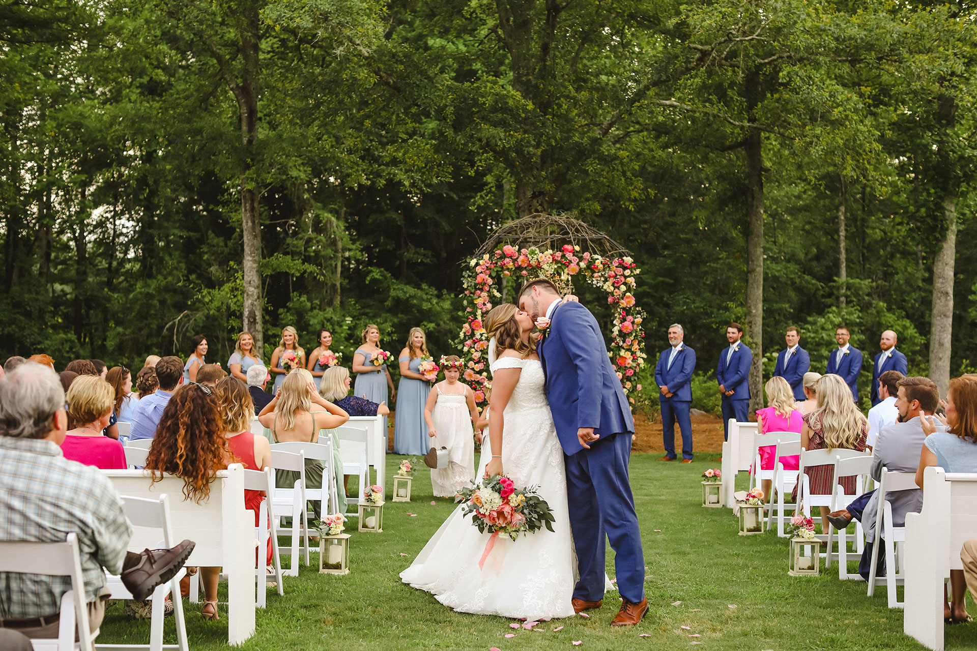 married couple kissing in front of crowd